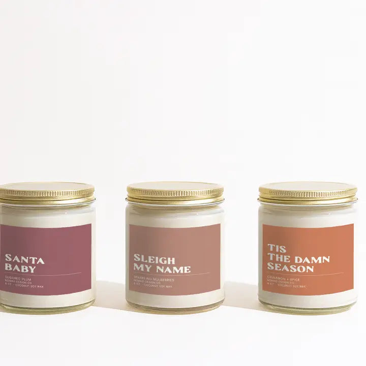 Three Holiday candles with labeled text on a white background