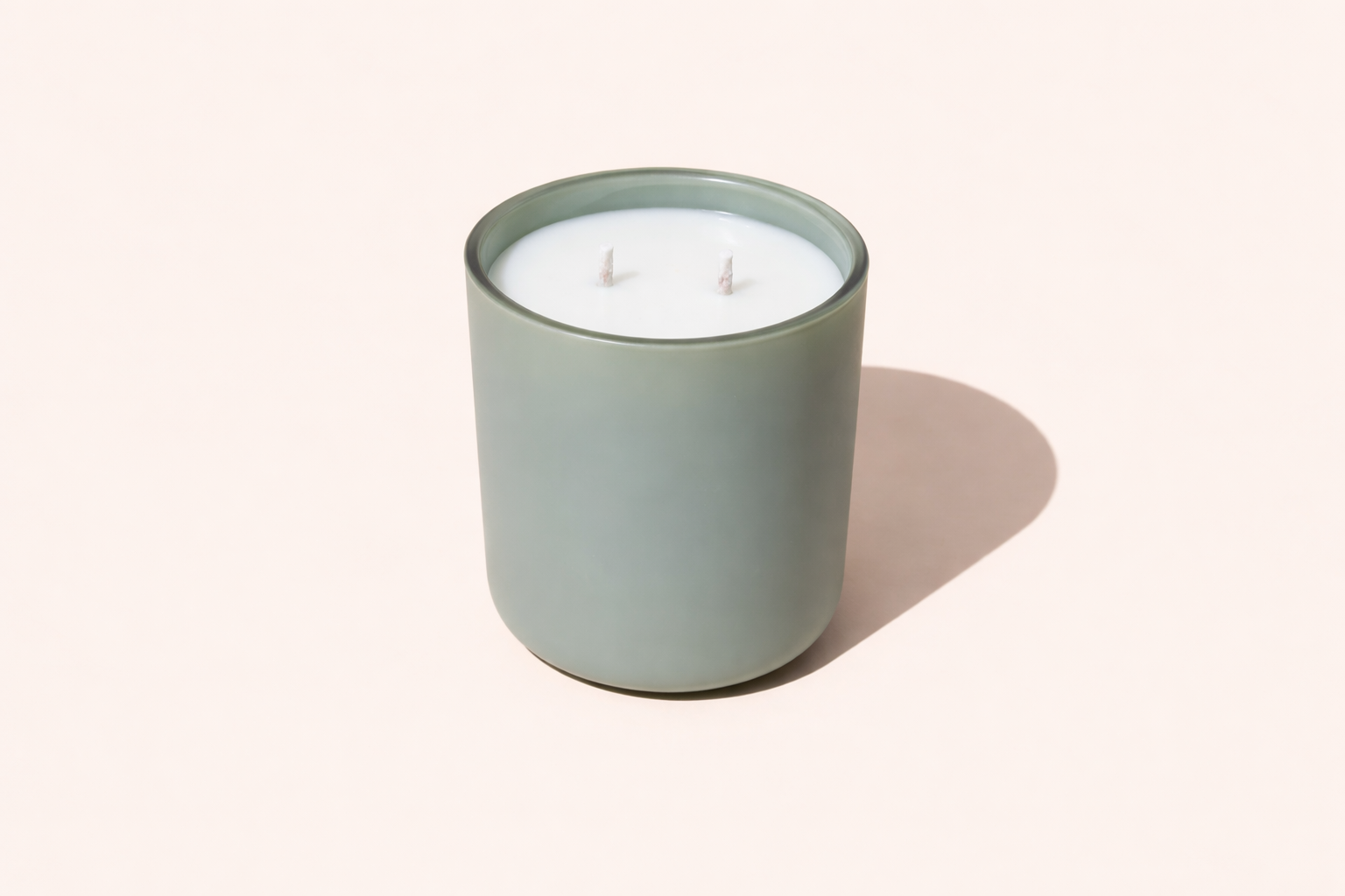 Candle in a green jar on a white background