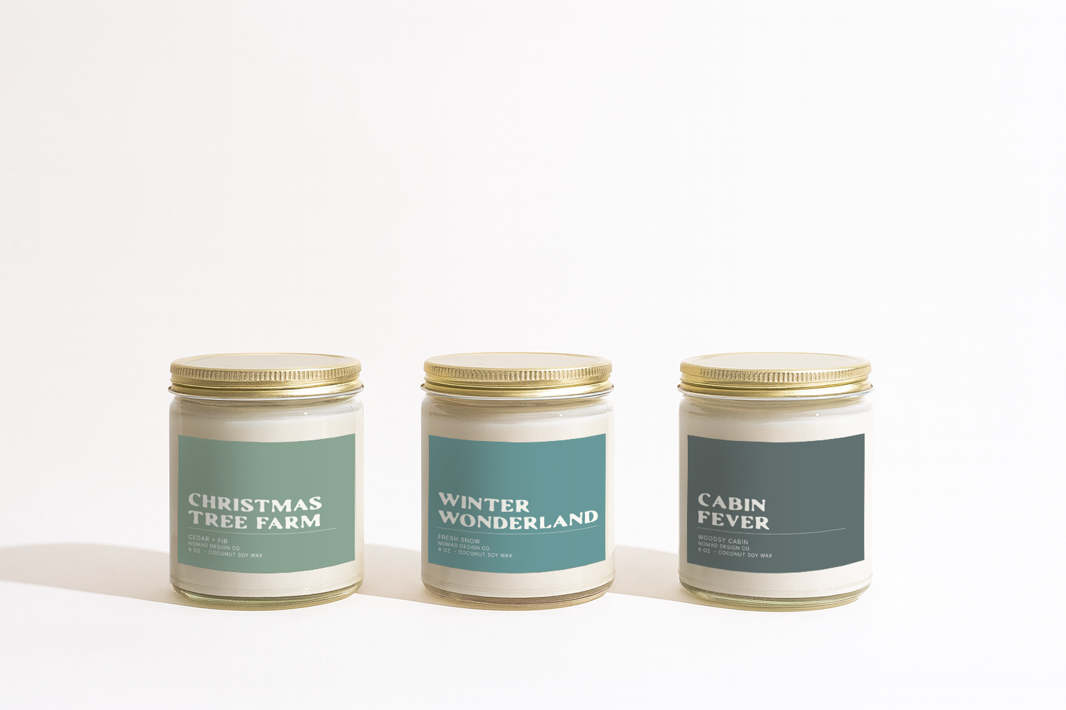Three candles with labels 'Christmas Tree Farm', 'Winter Wonderland', and 'Cabin Fever' on a white background.