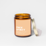 Amber candle jar with 'Free Spirit' label on a white background