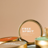 gold travel tin candles with 'Free Spirit' label
