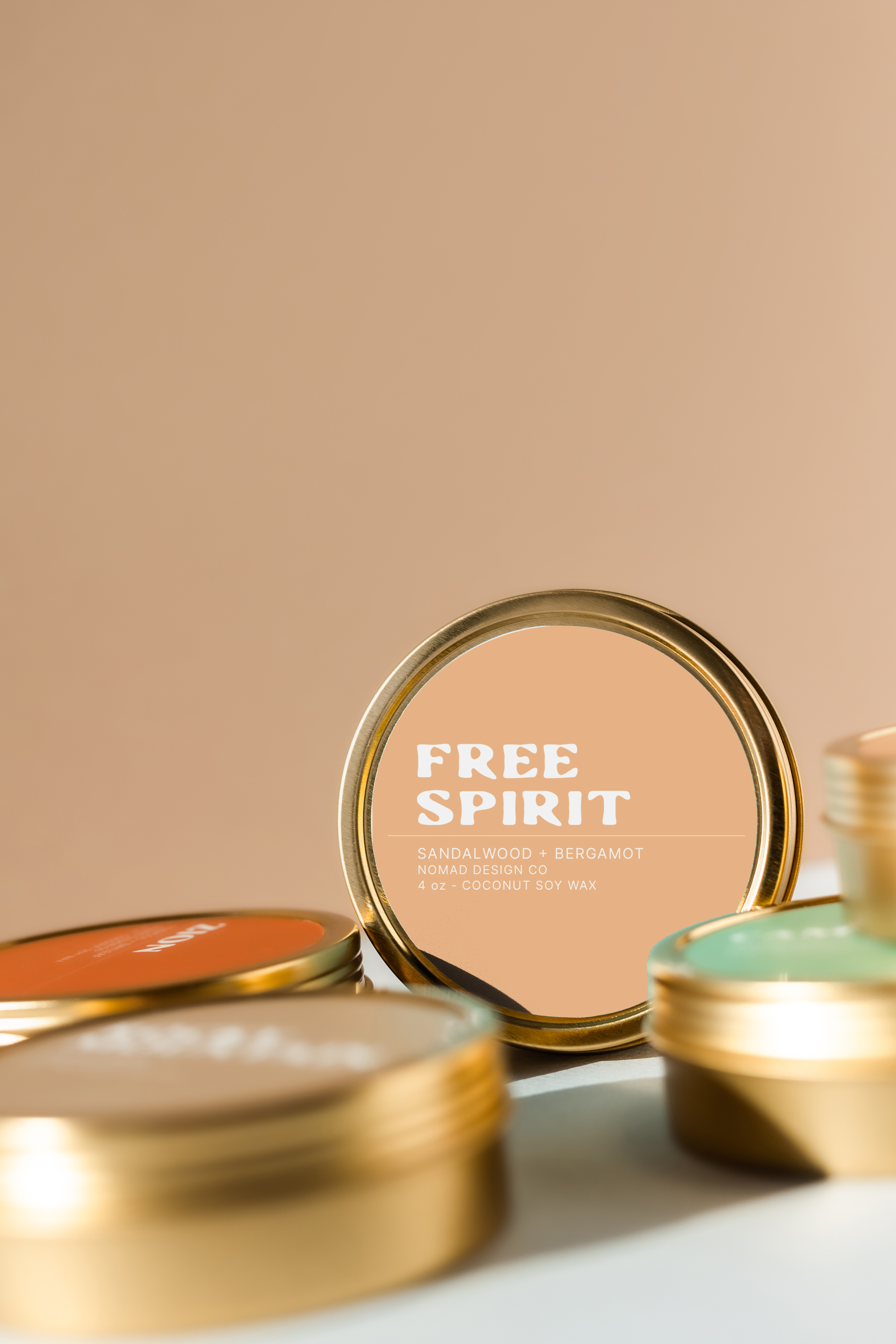 gold travel tin candles with 'Free Spirit' label