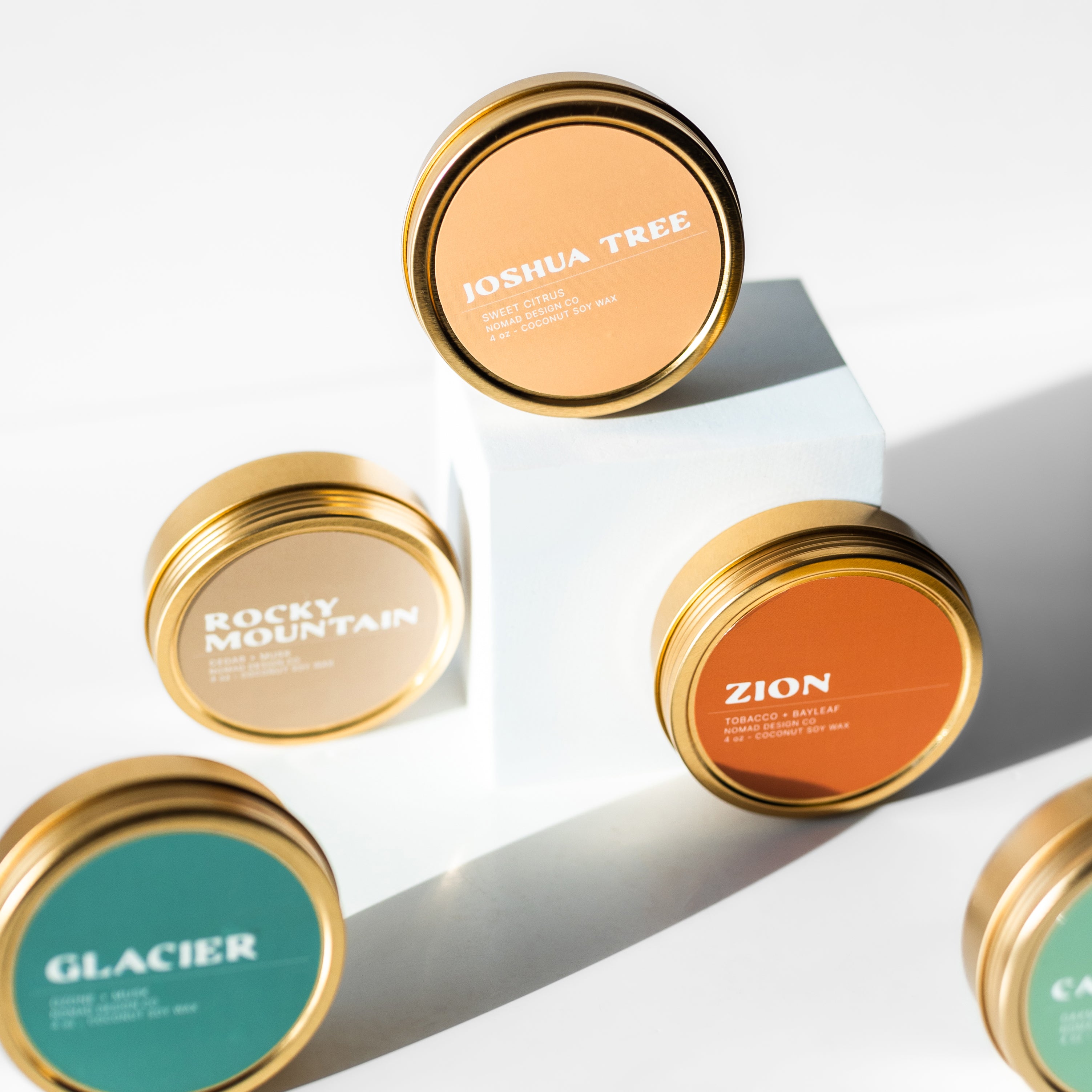 a collection of National Park themed travel tin candles