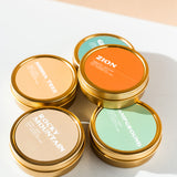 a stack of National Park travel tin candles