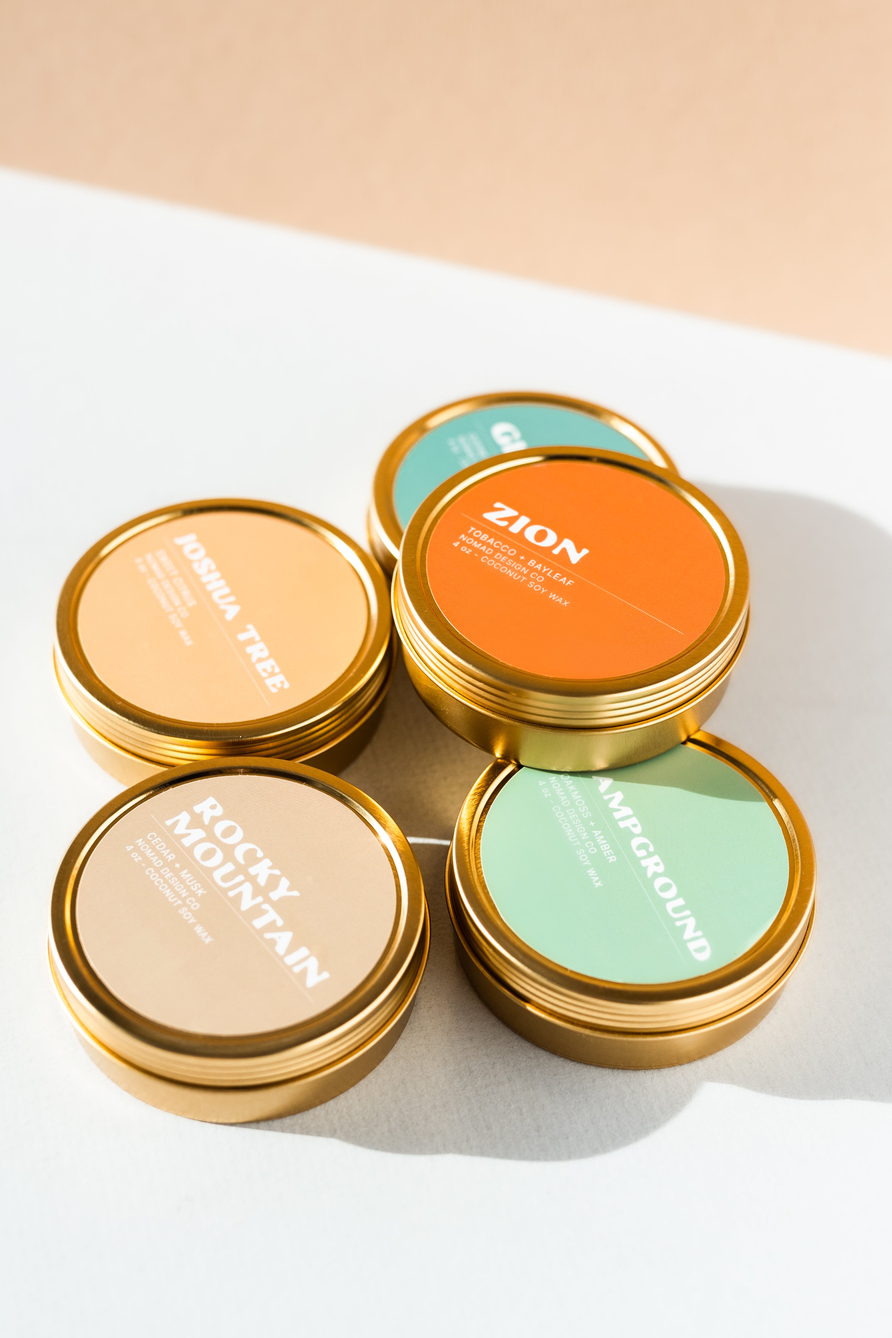 a stack of National Park travel tin candles